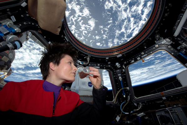 Italian astronaut Samantha Cristoforetti takes a sip of coffee made using the ISSpresso machine